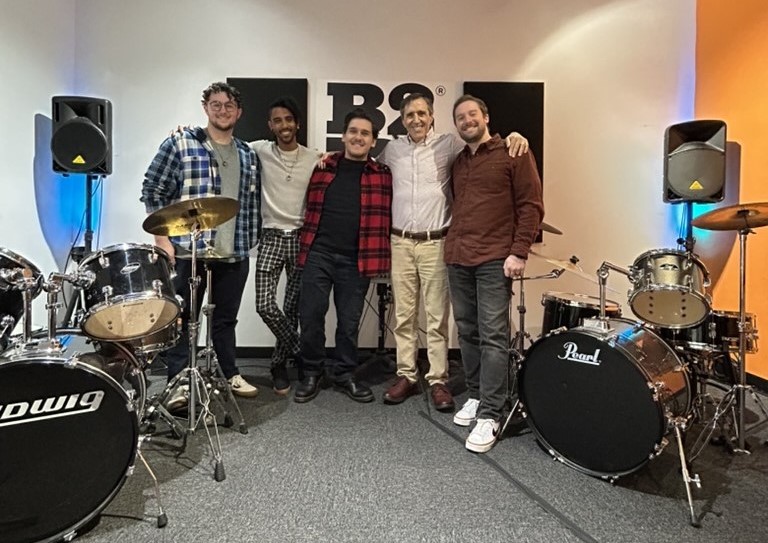 From left, band program leader Marc, senior teacher Nick, school director Joseph, Eric, and assistant director, Evan pose before a busy day at Bach to Rock Nanuet.